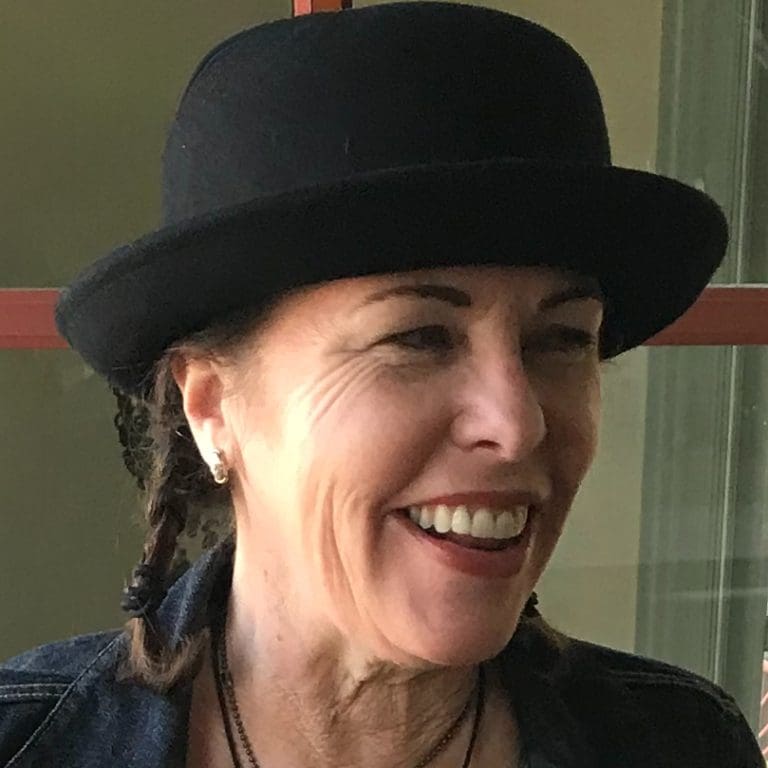 Yvonne Gardner in a dark hat smiling